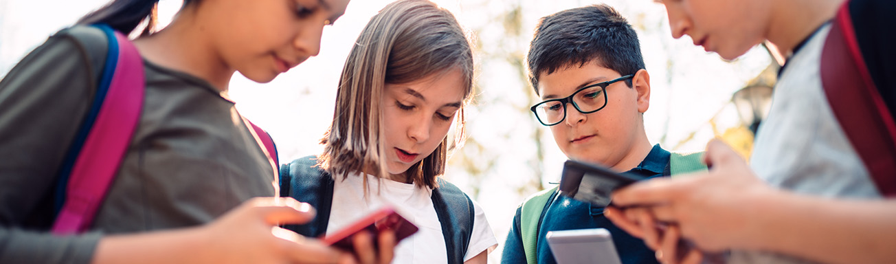 Children looking at their phones