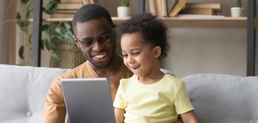 smiling parent and child looking at tablet