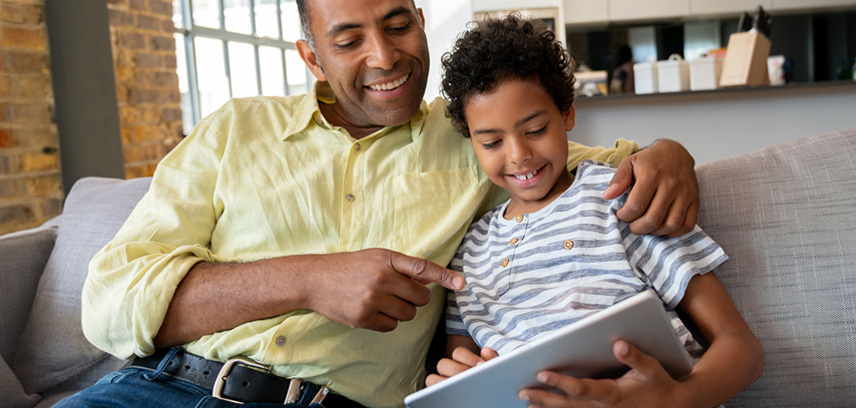 Dad showing son how to use AI