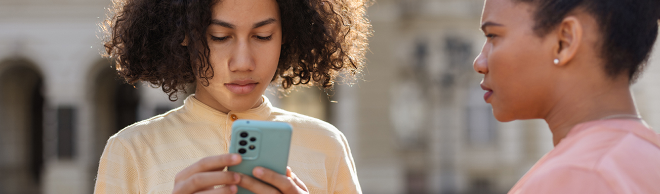 parent talking to child asking him to put down phone