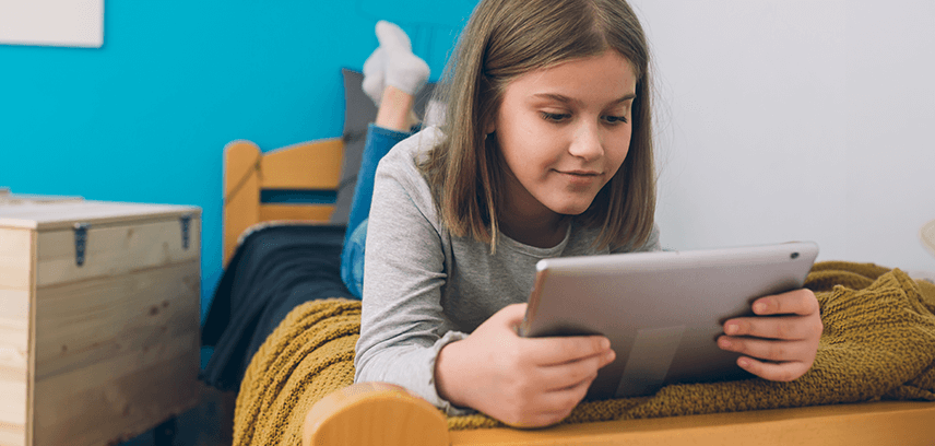 Young girl playing Roblox on tablet