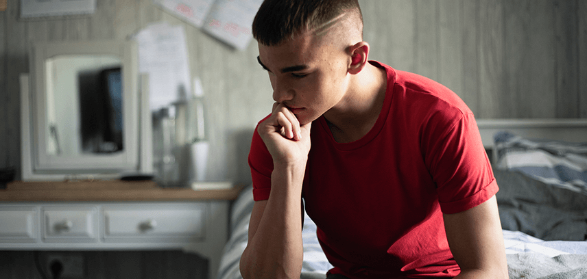 teenage boy looking pensive