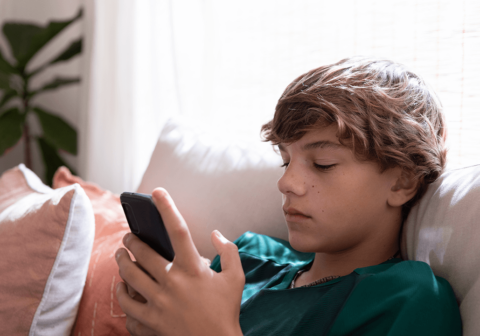 teenage boy viewing manosphere content on phone