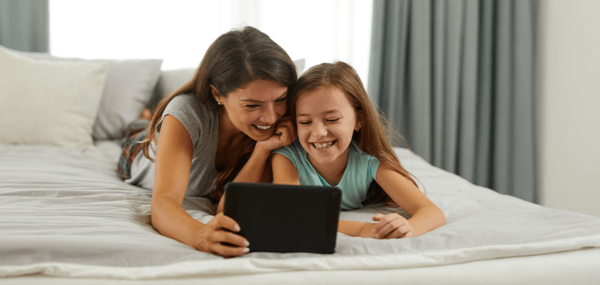 mother and daughter using tablet