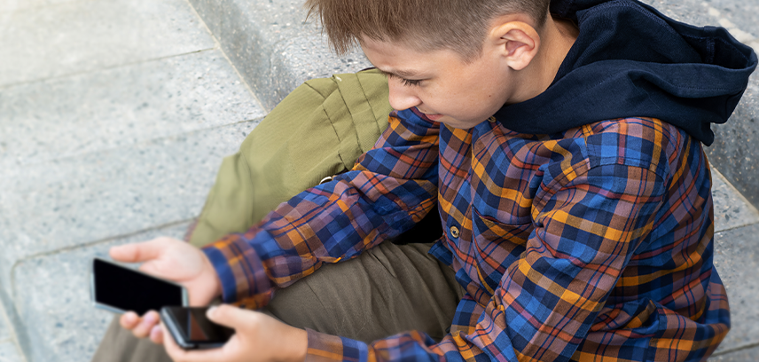 teenage boy using a burner phone