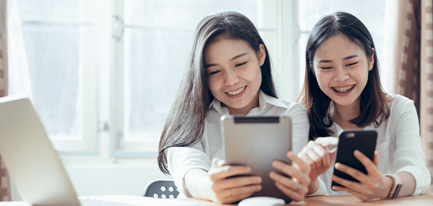 Two teenagers using Line app