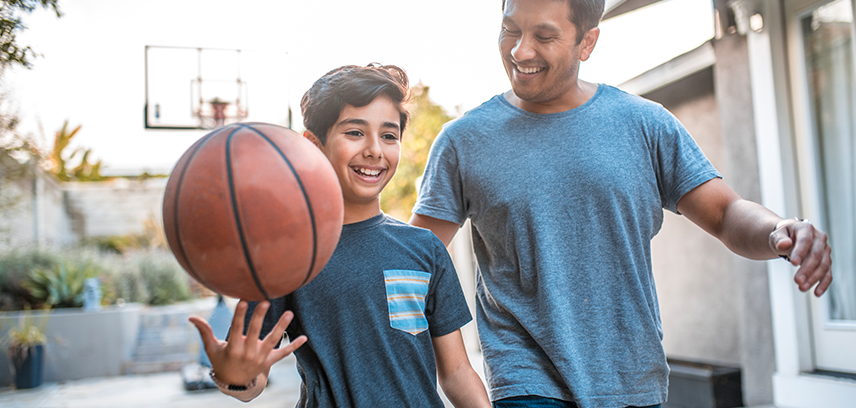Father playing basketball with his son